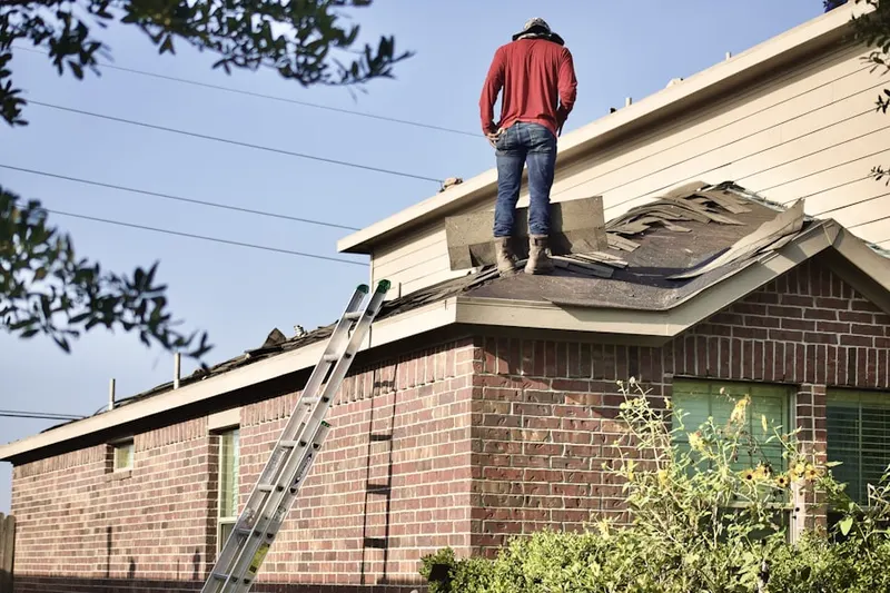 Professional roofer working on a residential roof in Huntingdon